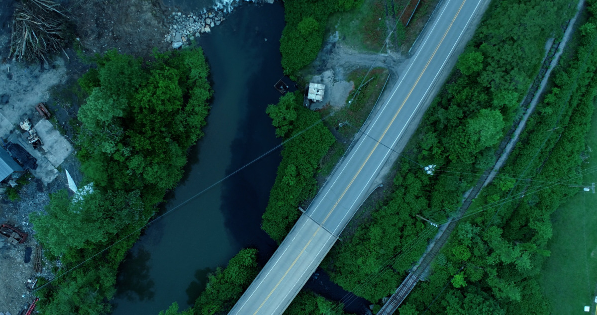 aerial shot of street going thru the twilight strip mine.