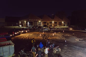 bird's eye view of dirt field with bikers