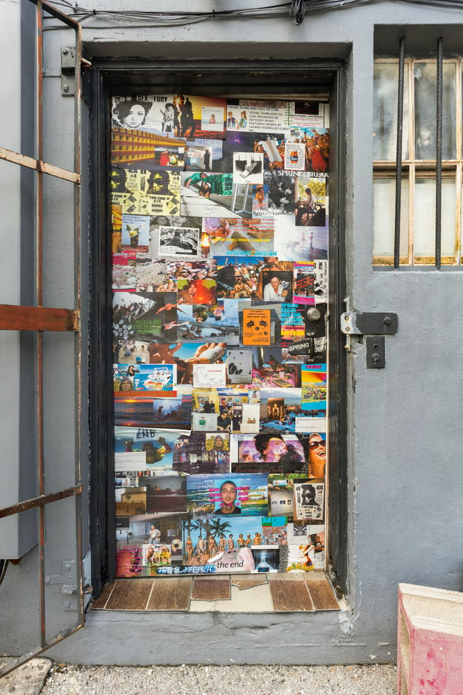 installation view of door covered in stock images
