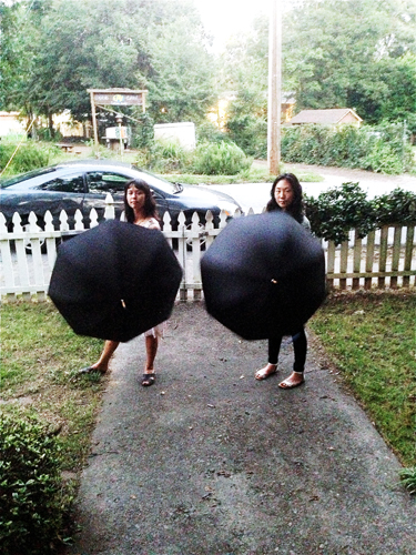 Tiger Moon with umbrellas (which they see as a “glorification of Asian women,” like in the film Pacific Rim) in Zopari Kristjanson’s front yard. Photo by Sherri Caudell for BURNAWAY.