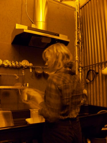 Dowda developing film in the darkroom at The Goat Farm Arts Center