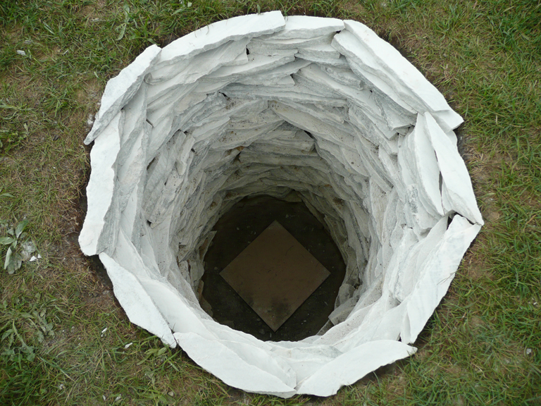 Cecelia Kane, Mother Hole, stacked marble shards in a hole. 