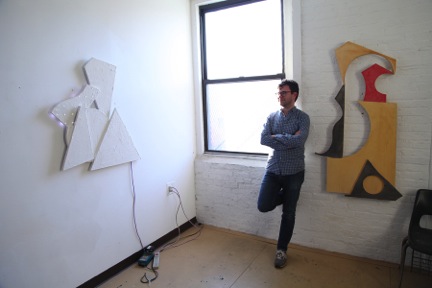 JD Walsh in his Brooklyn studio with, on left, 13/5, 2013; Hydrocol, wood, and LED lights.