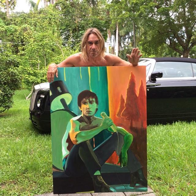 Iggy Pop with a painting of Iggy Pop by Ben Roosevelt. 