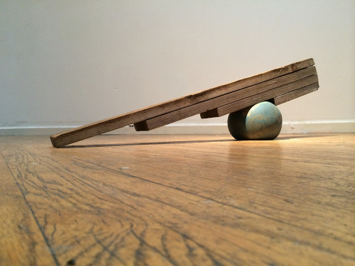 Curtis Ames, Pressured Ball, 2014; wood, ball, air, 50 by 9 by 12 inches. (Image: Candice Greathouse)