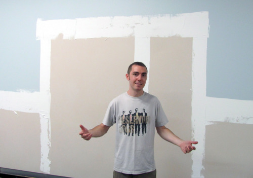 Danny Sanzone in front of a Scott Ingram painting. 