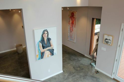 On the left facing wall hangs David Iacavozzi Pau's painting Holly, 2013. 