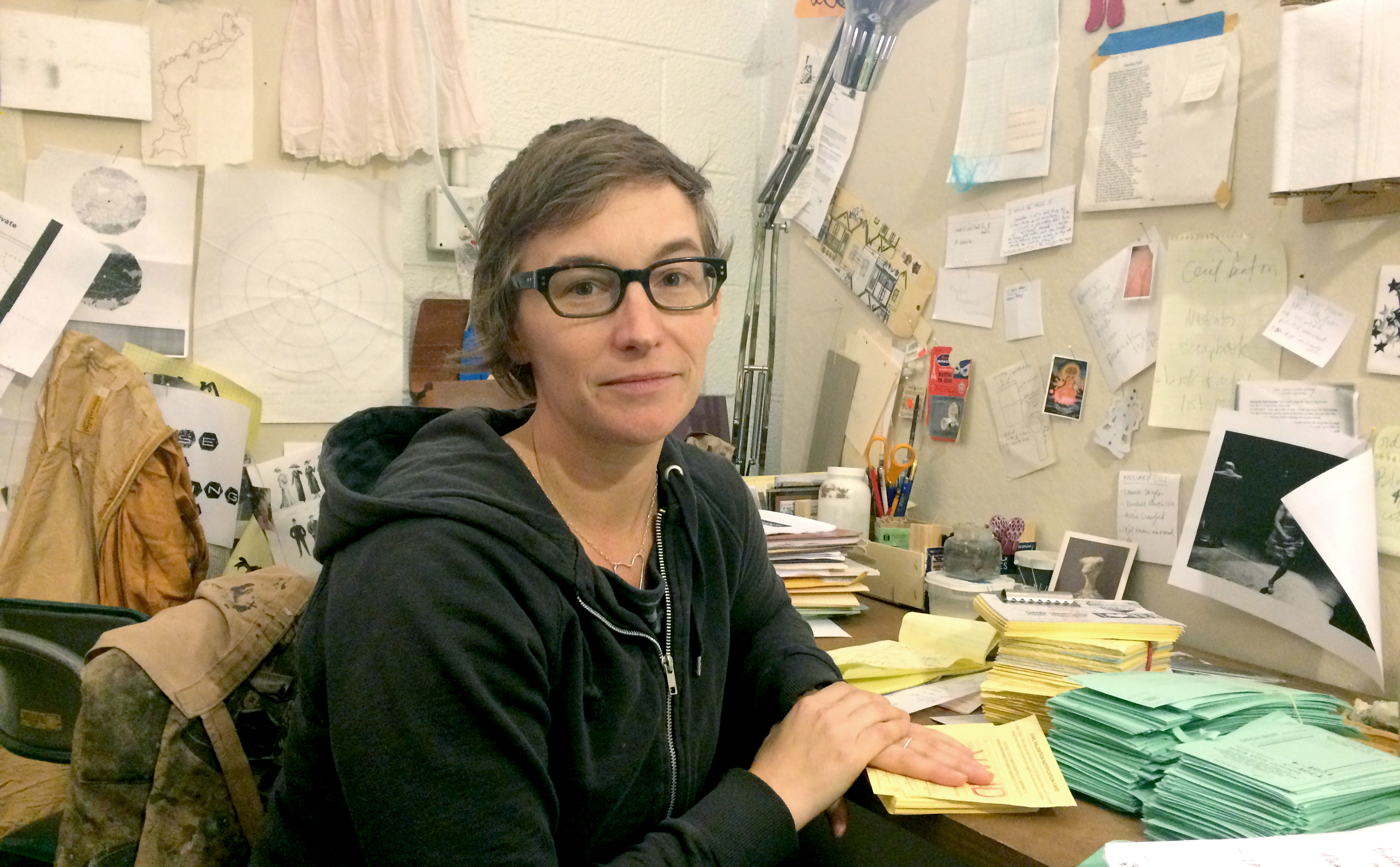 Stacey L. Kirby in her studio with documentation from "PARTicipate." (Photo: Kellie Bornhoft)