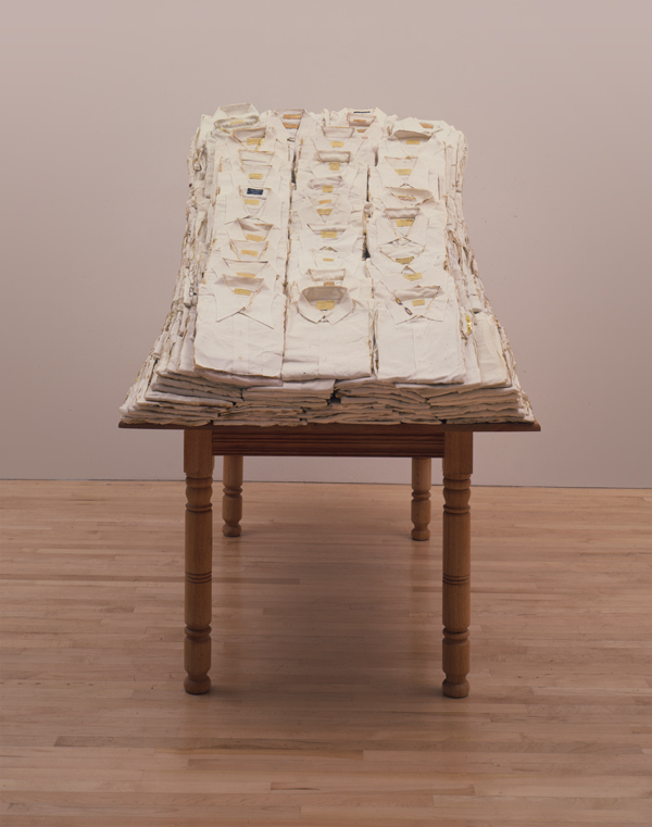 Ann Hamilton, Still Life, 1988/1991; white shirts, gold leaf, wood table, chair, 62 by 42 by 81 inches. Arthur Goldberg Collection. 