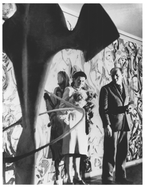 Peggy Guggenheim and Jackson Pollock in front of the mural she commissioned from the artist for her New York apartment.