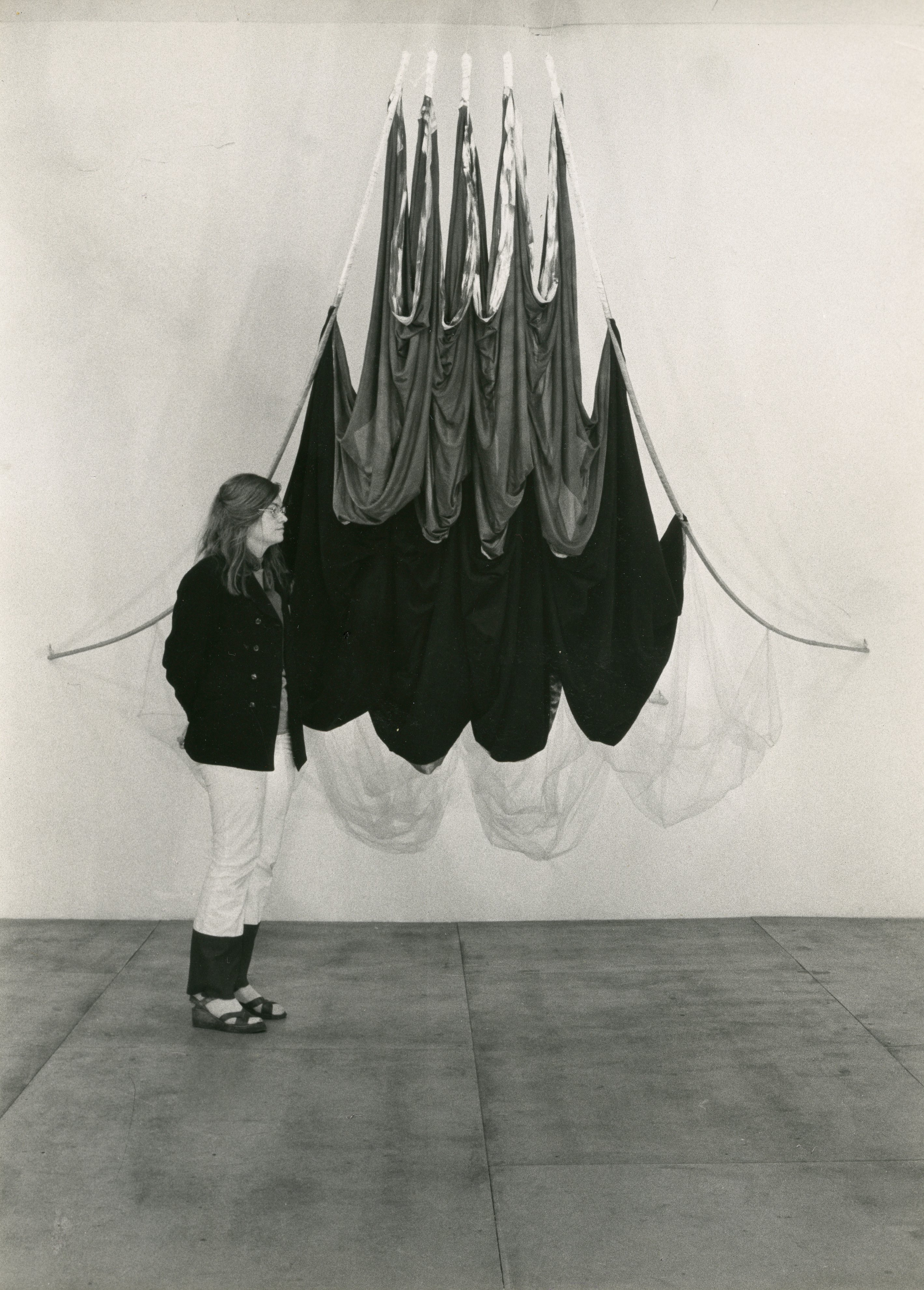 Photograph of Rosemary Mayer with one of her works from the 1970s.
