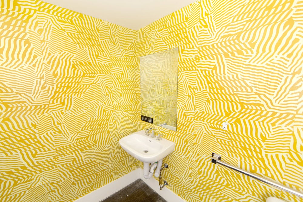 yellow walls of a bathroom with intricate line work