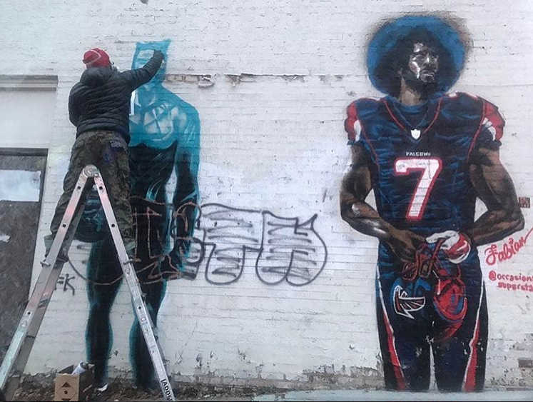 Fabian Williams painting Black Panther Ali next to Kap.