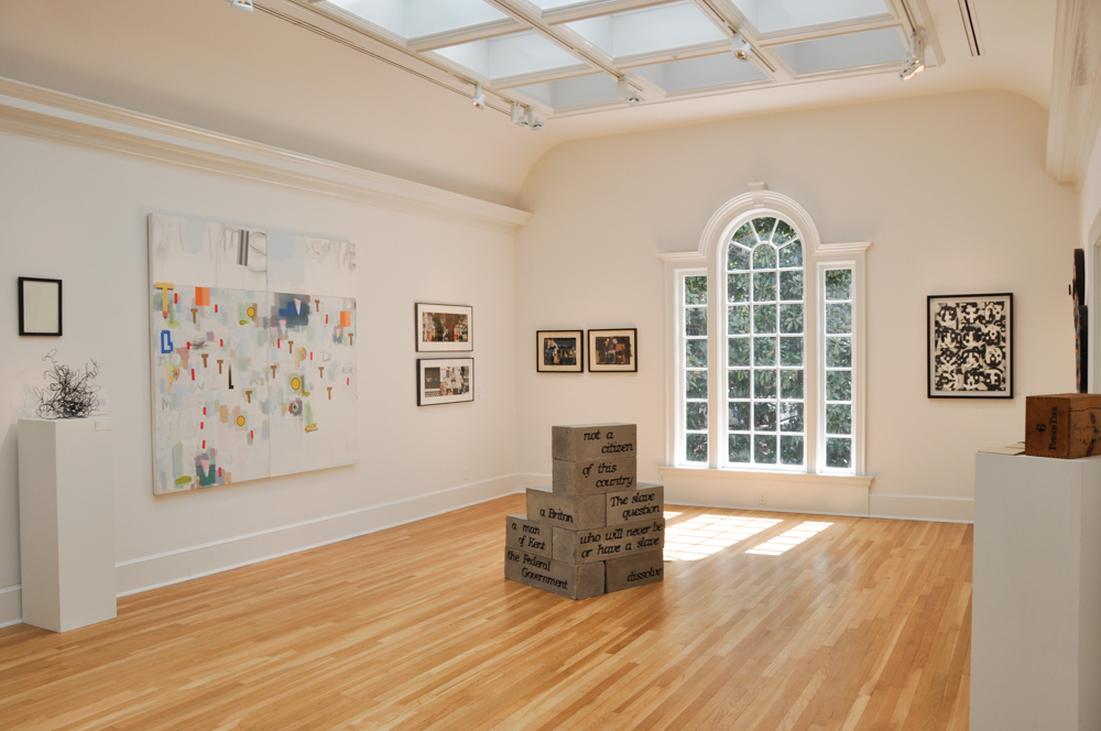 Installation view of "Beyond Words," with a painting by Craig Drennen on left wall, sculptures by Sarah Nathaniel on floor, and a work by Esteban Patiño on back right wall.