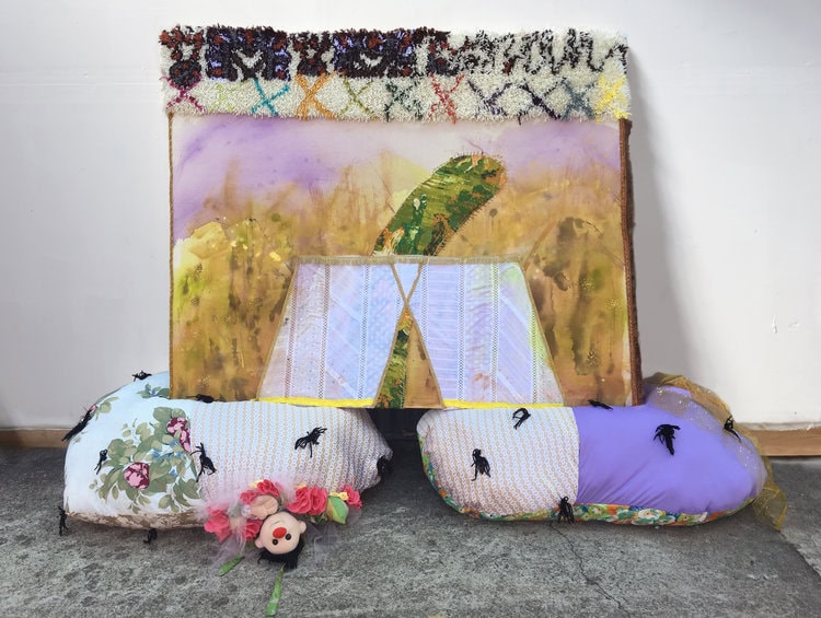Vivian Liddell, The King's Thirst Trap (The Softening), 2016, hooked rug, embroidery, fabric, trim, notions, red clay and synthetic polymer paint on canvas. Sitting on soft sculpture with found doll, and hand-sewn flowers, 60 by 86 by 28 inches.