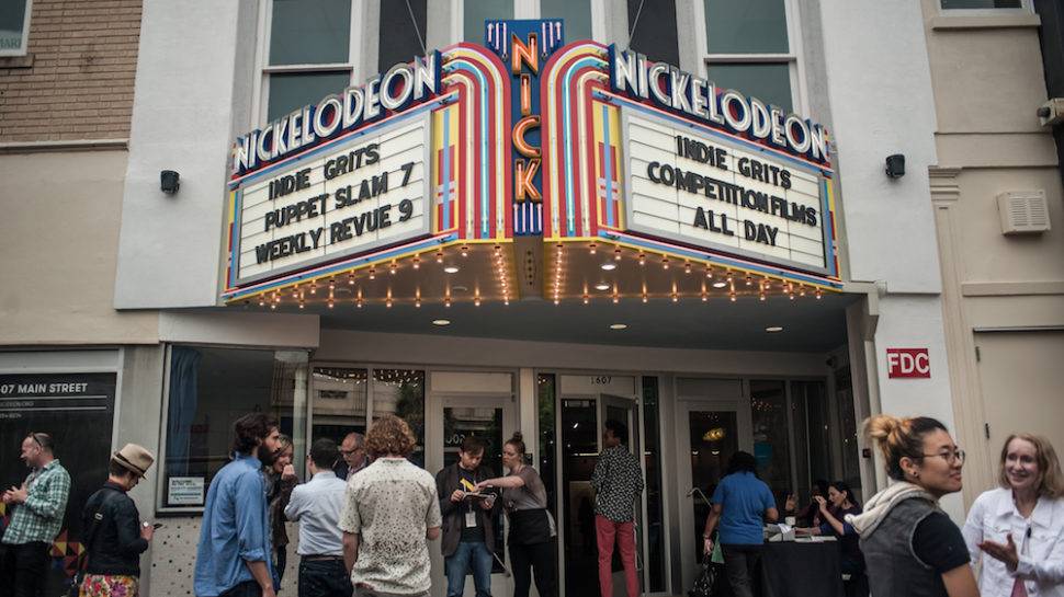 Marquee of the Nickelodian Theatre with people standing out front