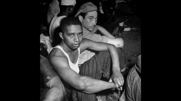 black and white image of two men sitting