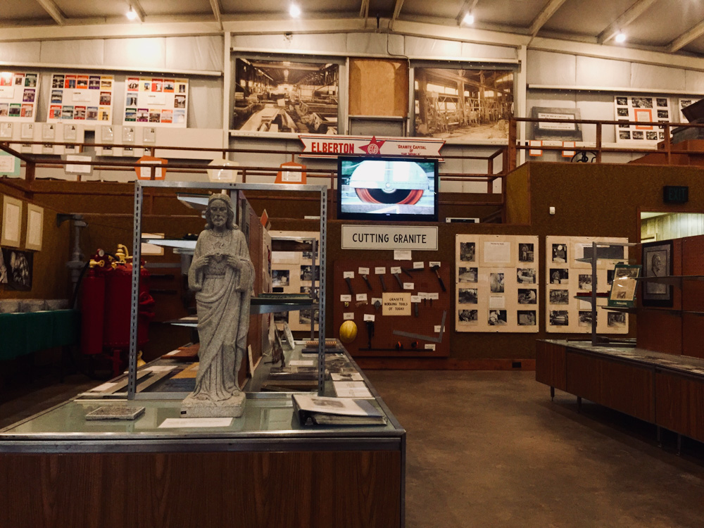 A room cluttered with exhibits about granite. 