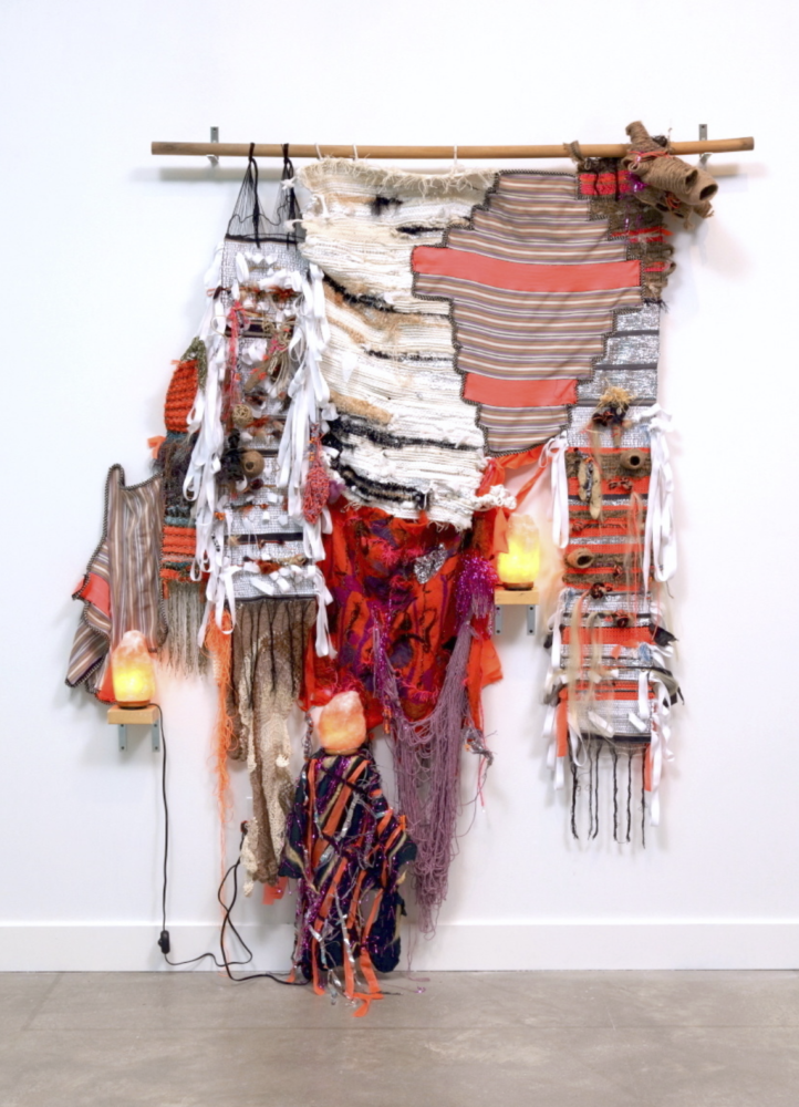 a colored textile installation hanging on the wall.