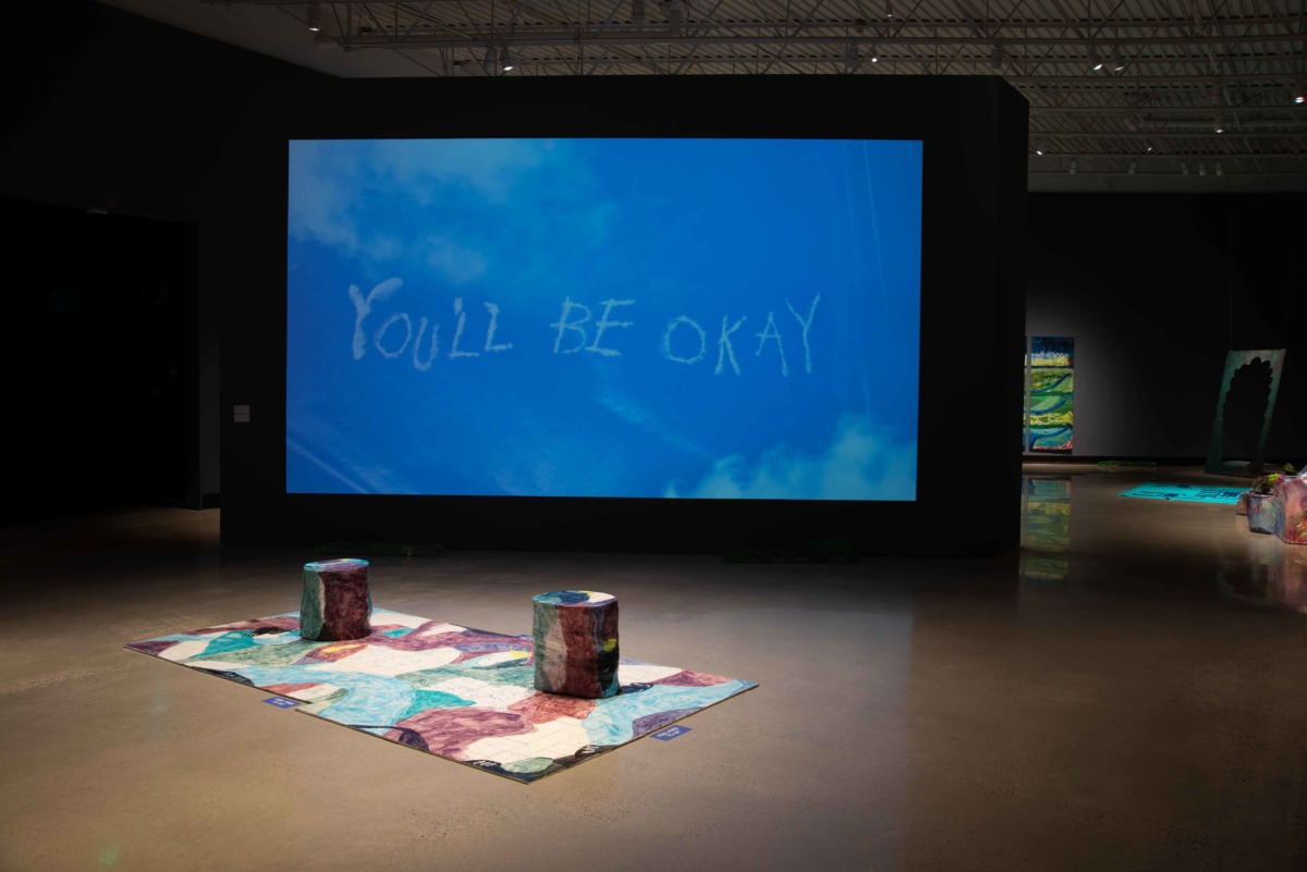 a video screen projects YOULL BE OKAY written by jet streams