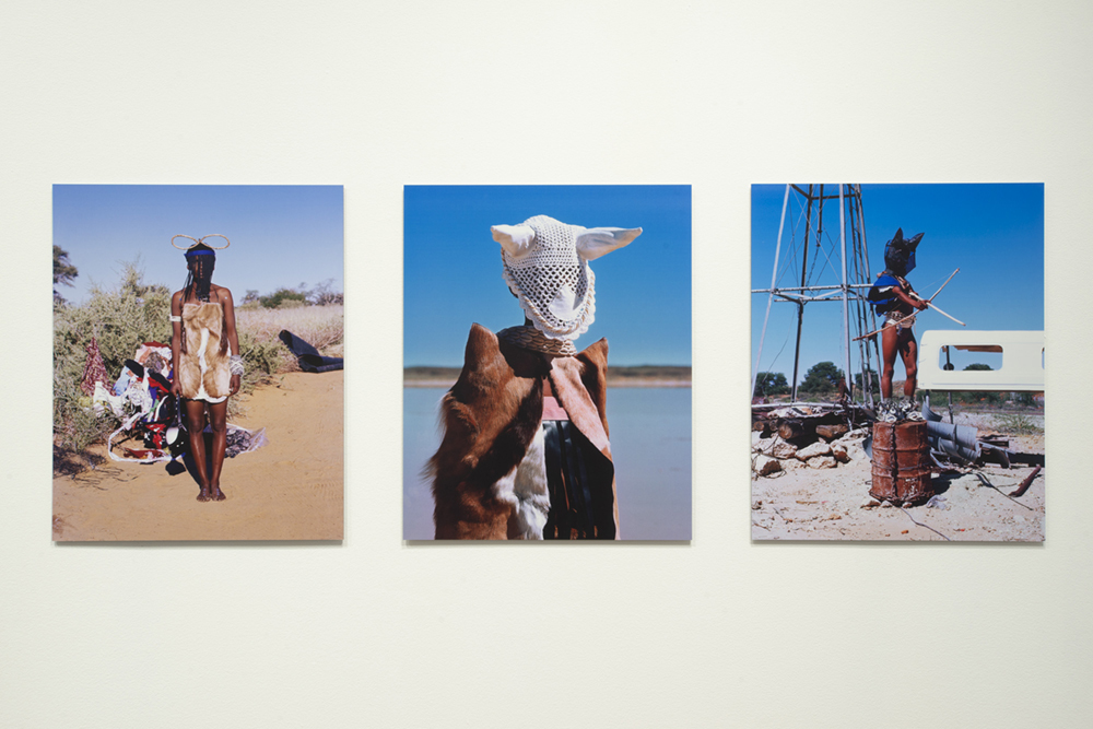 three portrait images of African people wearing animal skins against a blue sky 