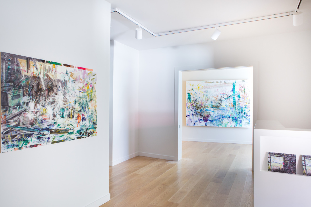 three modernist colorful paintings on a white wall