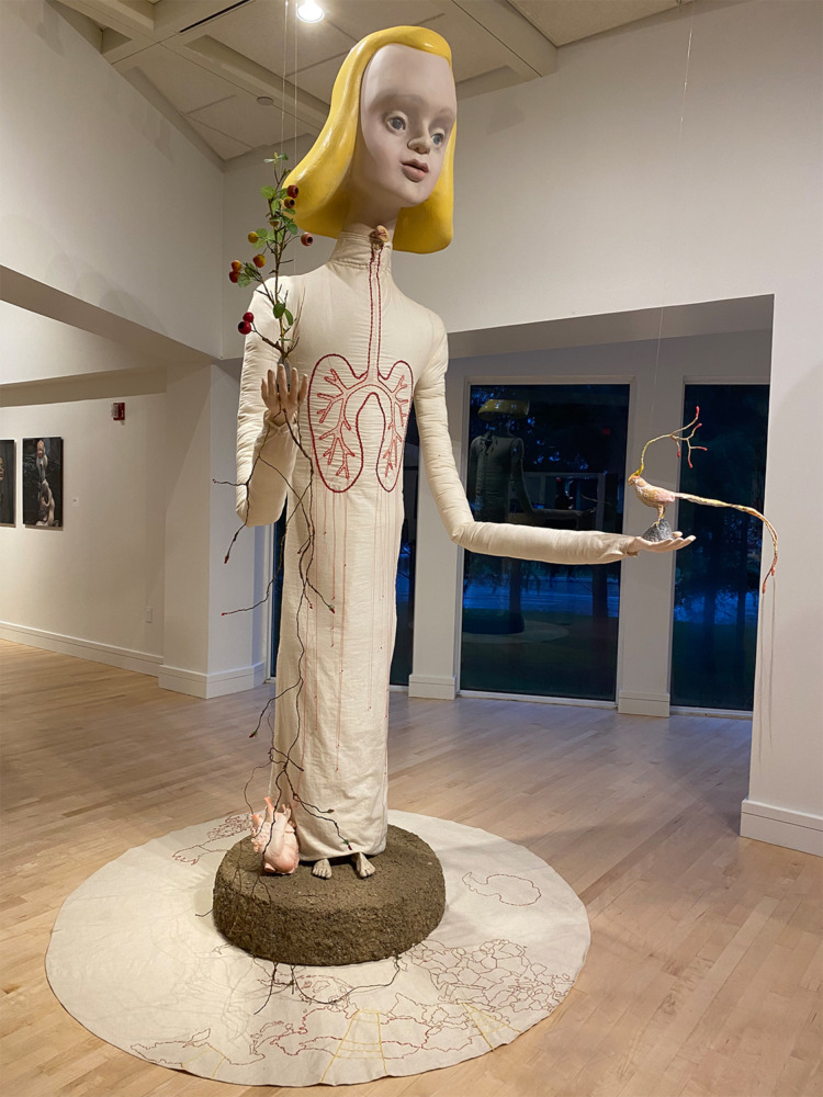tall alice with phoenix in hand in gallery windows in background