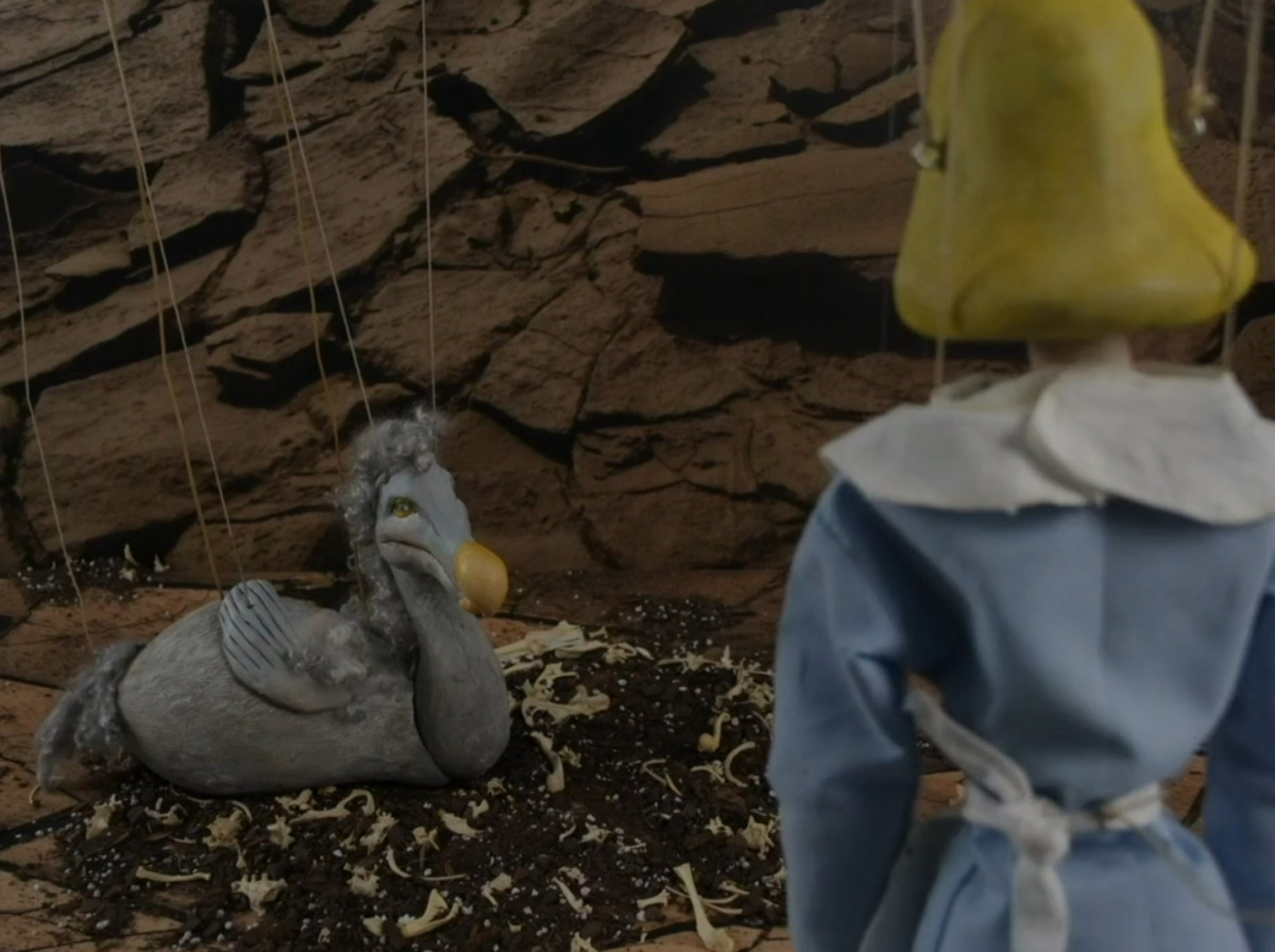 alice with dodo bird and bones in cave stop motion marionette puppets