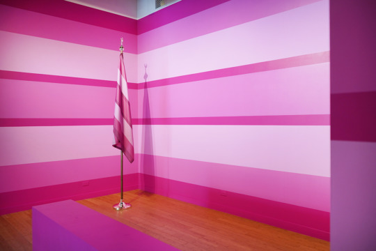 pink striped walls with pink white flag on wooden floor