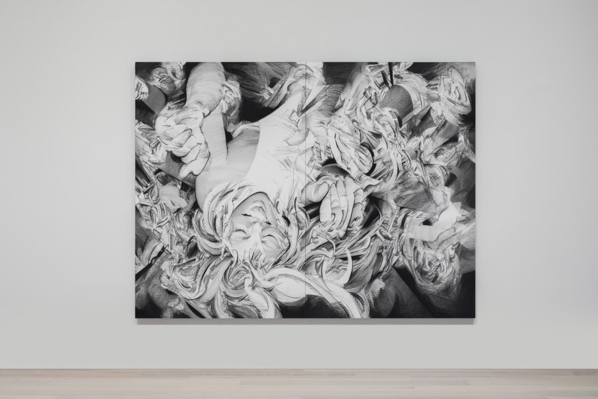 frontal image of black and white work with upside down figure encircled by hands