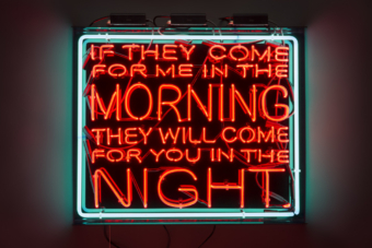 LED sign with green frame and red letters, reading "If They Come For Me In The Morning, They Will Come For You In The Night," a quote by James Baldwin to Angela Davis