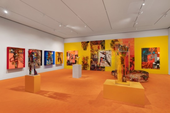 installation view of bright orange and yellow exhibition