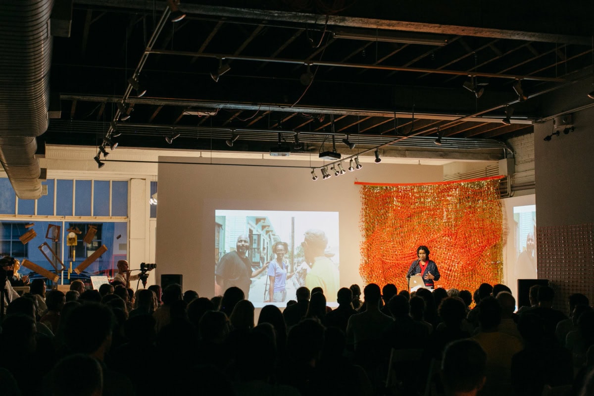 distanced shot of audience listening to artist speaker