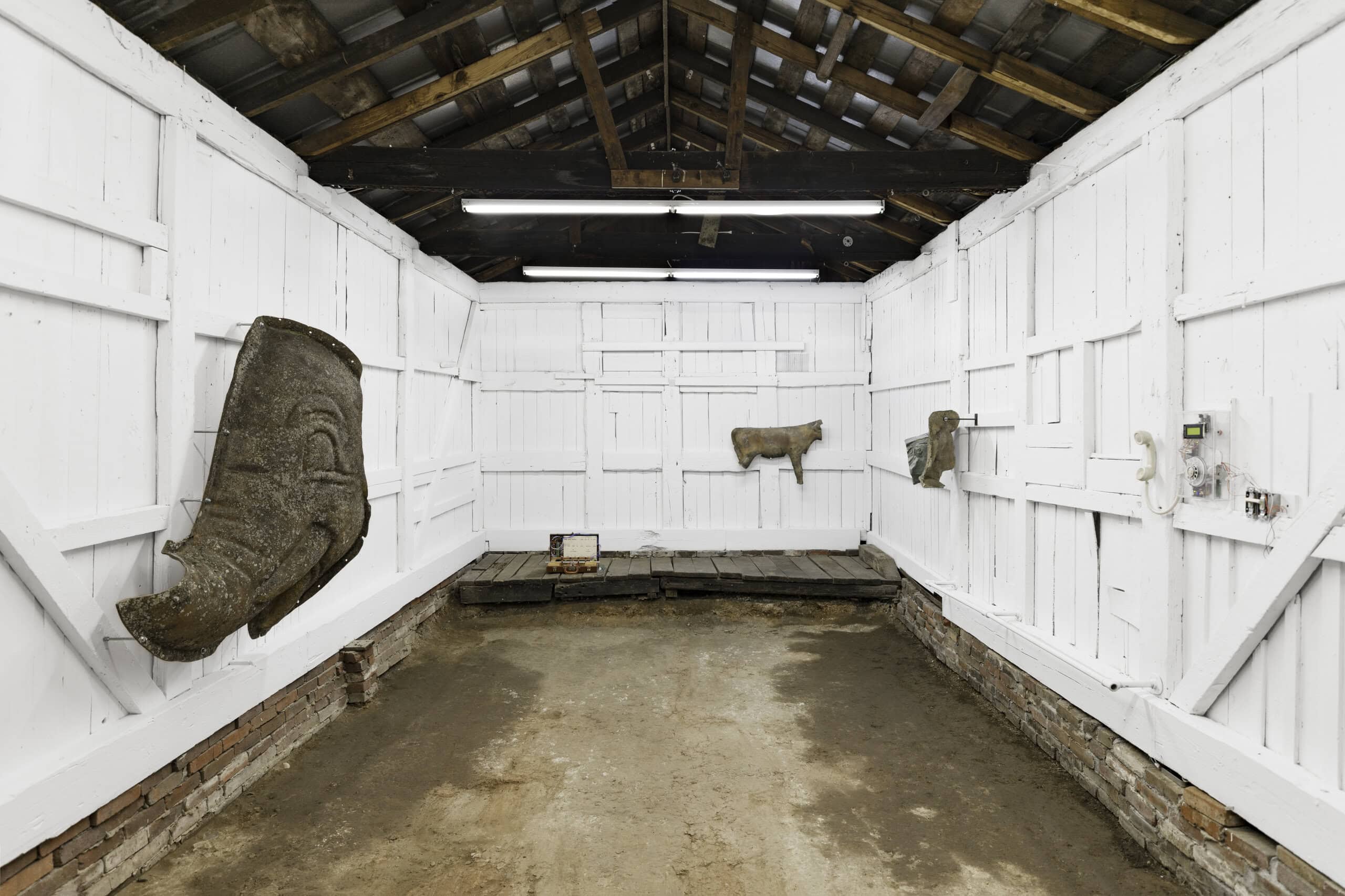 installation view of gallery with white walls and sculpture