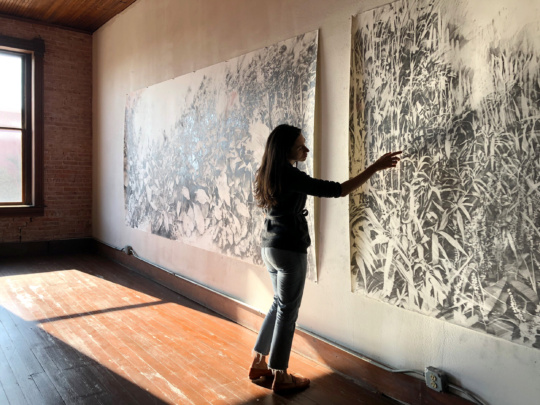 image of woman against a large artwork