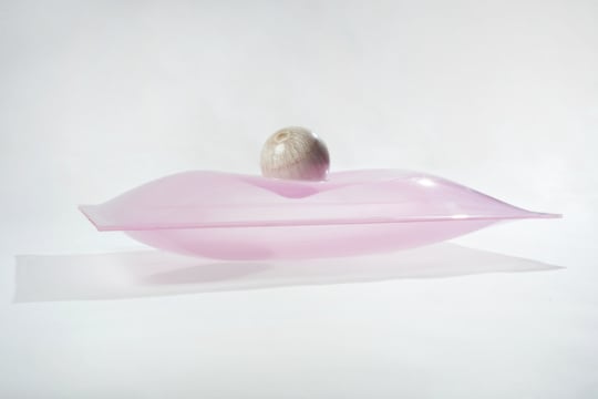 image of a pearl balanced on a glass pillow